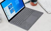 gray microsoft surface laptop computer on white table