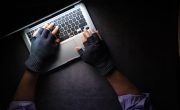 person in black long sleeve shirt using macbook pro