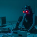 A Person Sitting on the Floor with Vr Goggles Using a Computer