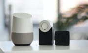 white and gray Google smart speaker and two black speakers