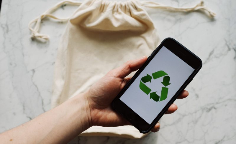 Free Faceless person showing recycle symbol on mobile phone screen Stock Photo