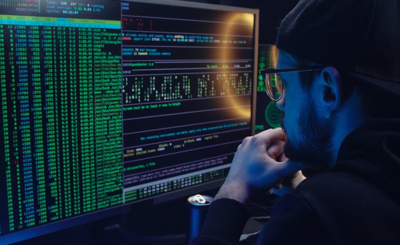 Free A Man Looking at a Computer Screen with Data Stock Photo