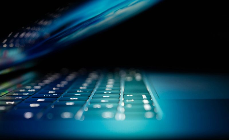 closeup photo of turned-on blue and white laptop computer