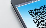 Free High-resolution close-up of a smartphone displaying a QR code on its screen. Stock Photo